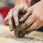 Hands shaping clay