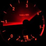 A car's tachometer lit up in red